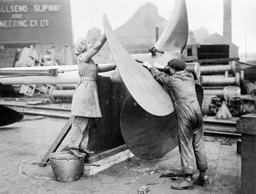 A female worker assists with the alignment of a ship's propeller on Tyneside